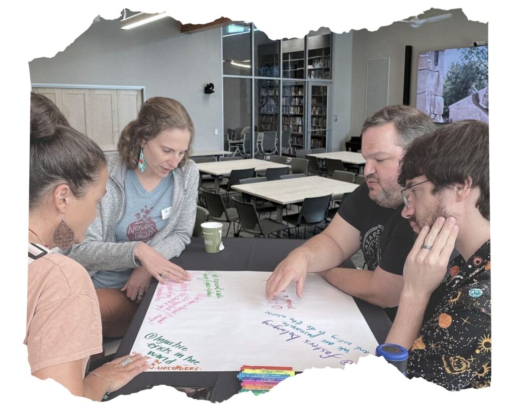 Educators gathered around a table working together.